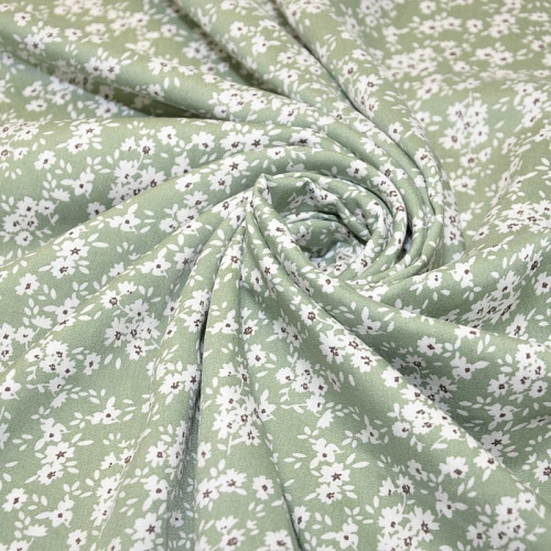 Штапель принт полянка  на фоне фисташка