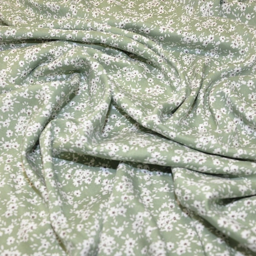 Штапель принт полянка  на фоне фисташка